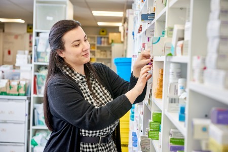 Image of a pharmacist selecting products from a shelf