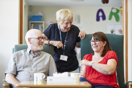 Picture of three people talking to each other in a hospice setting