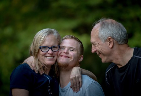 young person with a learning disability with his parents.jpeg